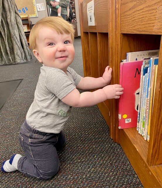 One of Robyn Kelly's children selecting books at Florence-Lauderdale Public Library