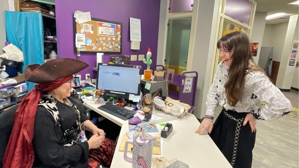19-year-old Isabella Emerald laughs with Teen Services Librarian Allyson Russell at the Fairhope Public Library